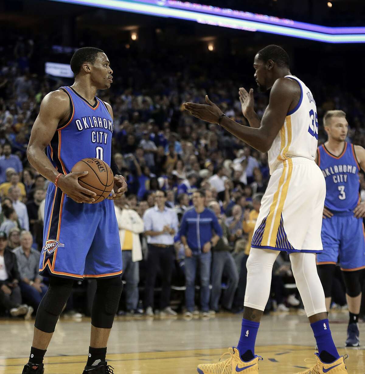Golden State Warriors' Kevin Durant, right, celebrates in front of Oklahoma City Thunder guard Russell Westbrook (0) during the first half of an NBA basketball game Thursday, Nov. 3, 2016, in Oakland, Calif. (AP Photo/Ben Margot)