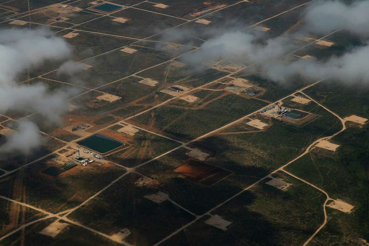 An aerial view of the Permian Basin outside of Midland shows the football field-size rectangles of land cleared by oil drillers.