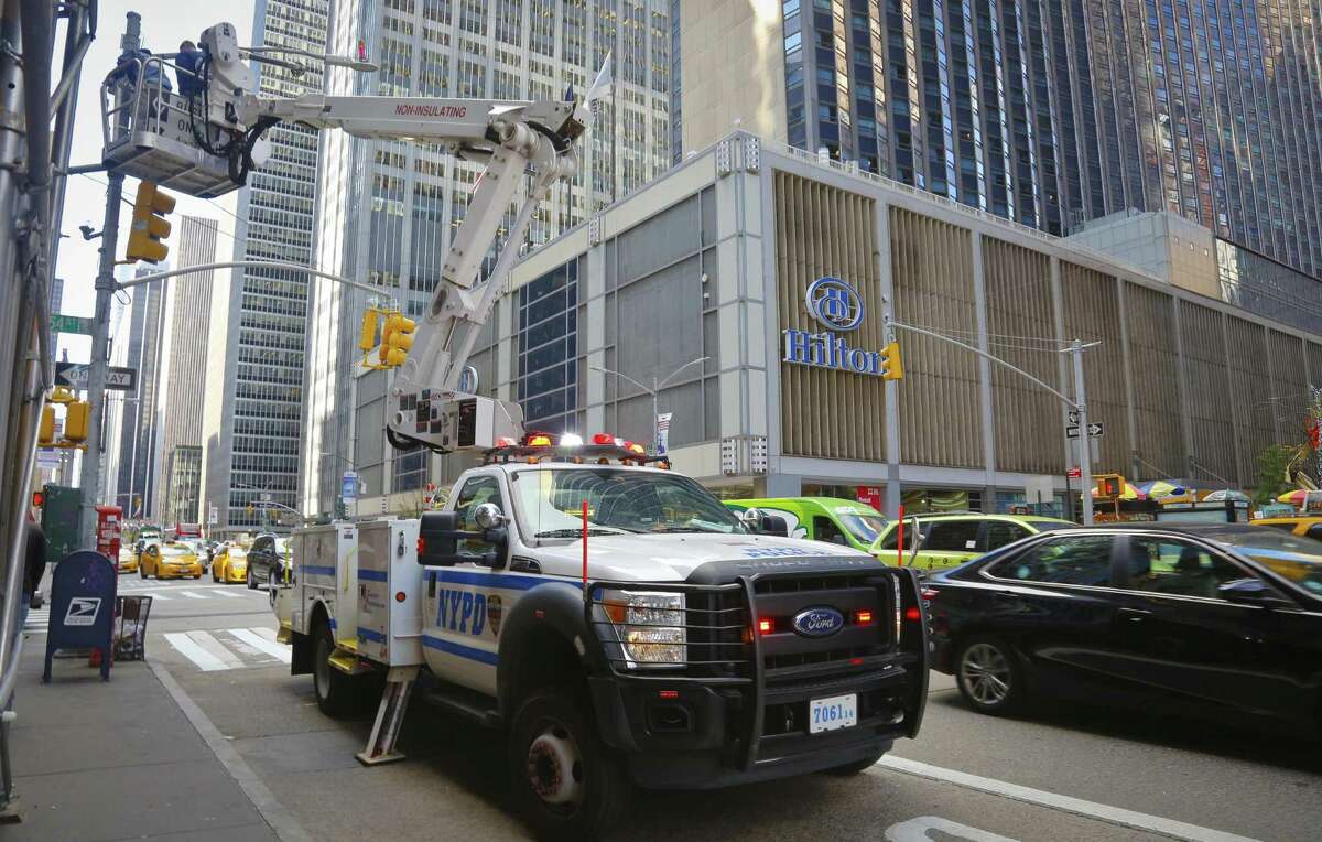 NYPD install police security camera near the Hilton hotel in New York, Friday Nov. 4, 2016, where Donald Trump organizers will gather on election night. The FBI and New York Police Department say they are assessing the credibility of information they received of a possible al-Qaida terror attack against the U.S. on the eve of Election Day. Officials say Friday that counterterrorism investigators are reviewing the information that mentioned New York, Texas and Virginia as potential targets. An NYPD spokesman says in a statement the information "lacks specificity." (AP Photo/Bebeto Matthews)