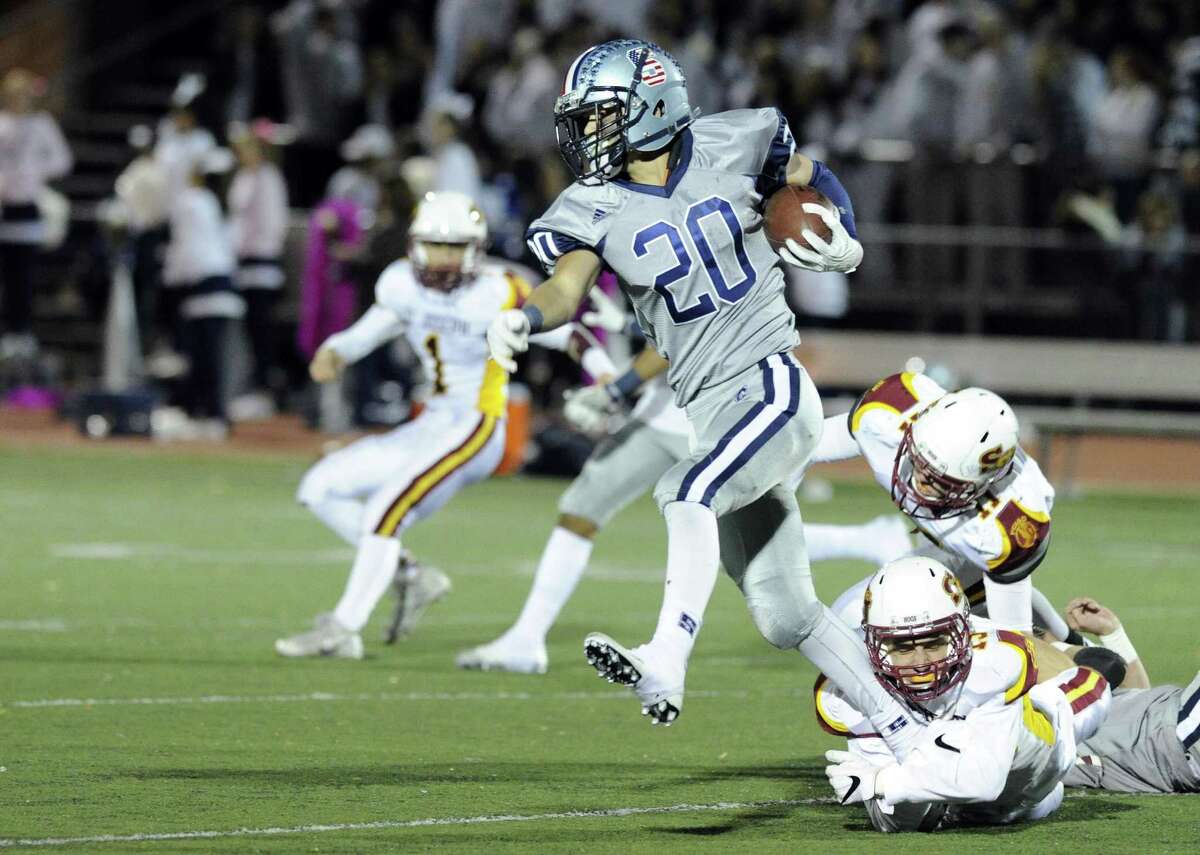 Staples Elliott Poulley breaks away from St. Joseph defenders on his way for a touchdown in Friday night’s
