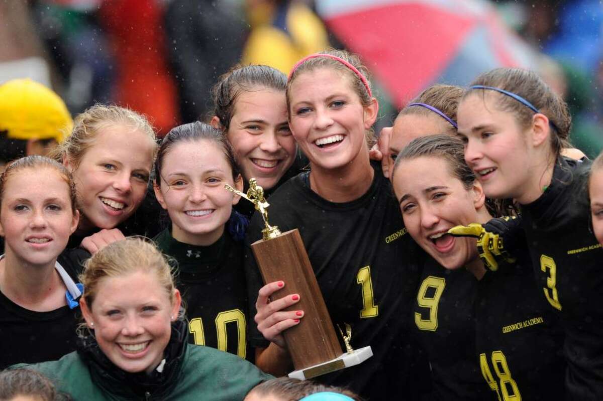 Members of the Greenwich Academy girls lacrosse team celebrate their 10-8 FAA Championship victory over rival Convent of the Sacred Heart, at GA, , Tuesday, May 18, 2010. They are, Hannah Bacon (lower left) Kara Sperry, Emily Conway, Sarah Canning, Kathryn Stack, Lilly Fast (holding trophy), Caroline Feeley, and Alexa Pujol (far right), Tuesday.