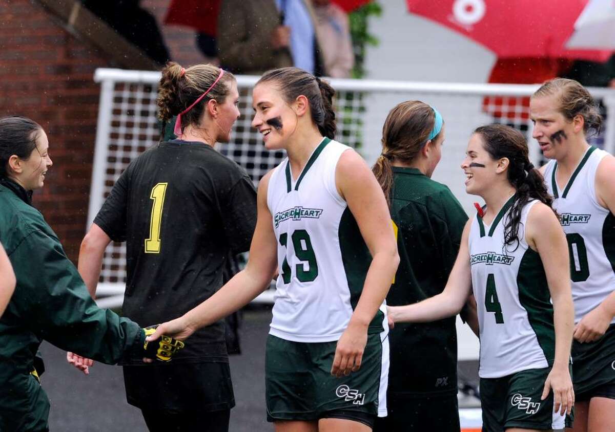 Convent of the Sacred Heart captain, Deidre Miller, # 19, center, congratulates Sarah Canning, left, at the end of the FAA Championshop game at GA which GA won 10-8. Also in photo are Annie Verrochi, # 4, and Gillian Burkett, # 30, of CSH, # 1 for GA is Lilly Fast.