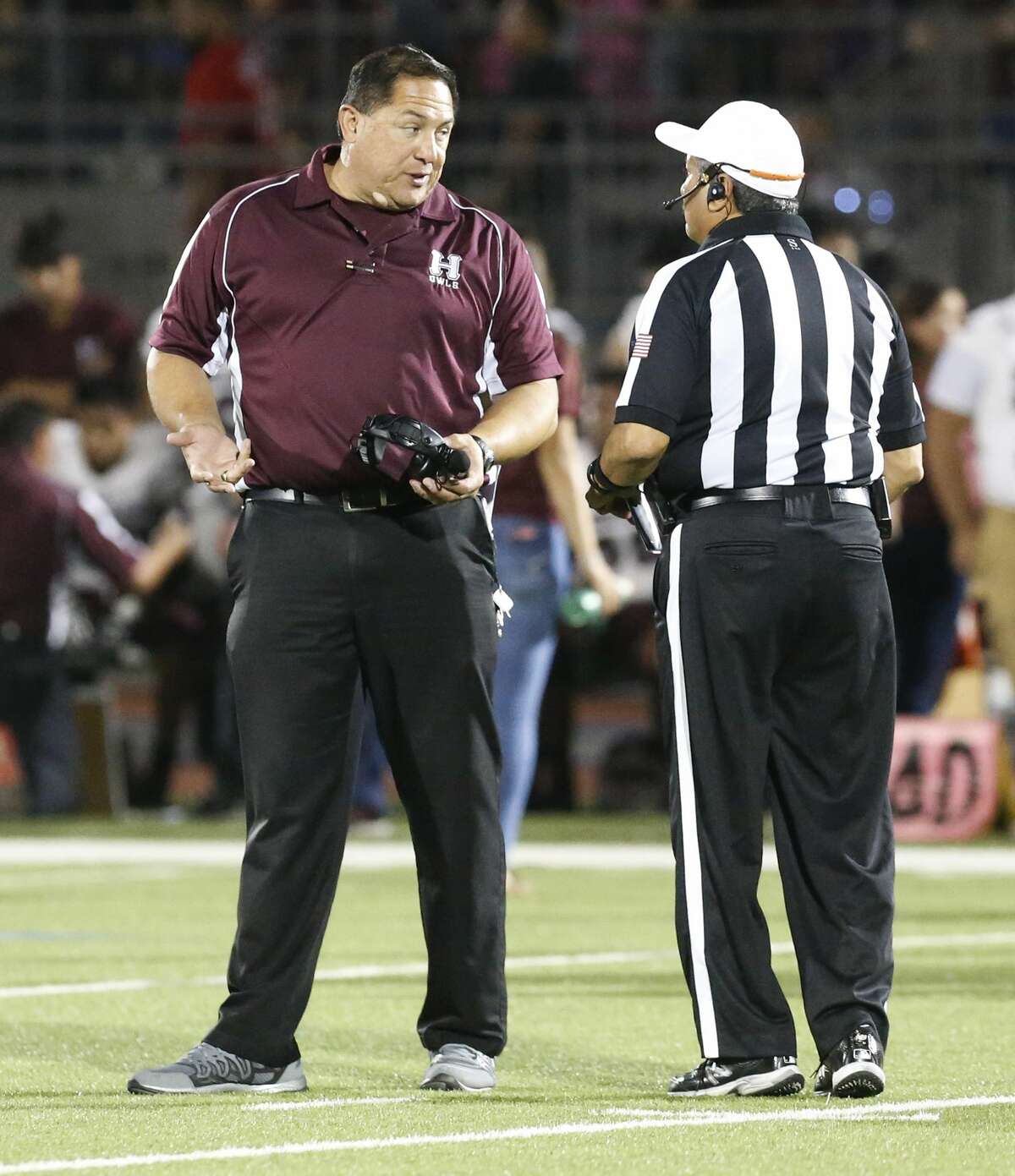 Highlands' coach Juan Morales talks with a game official during the game against Brackenridge at Alamo Stadium on Friday, Nov. 4, 2016. (Kin Man Hui/San Antonio Express-News)