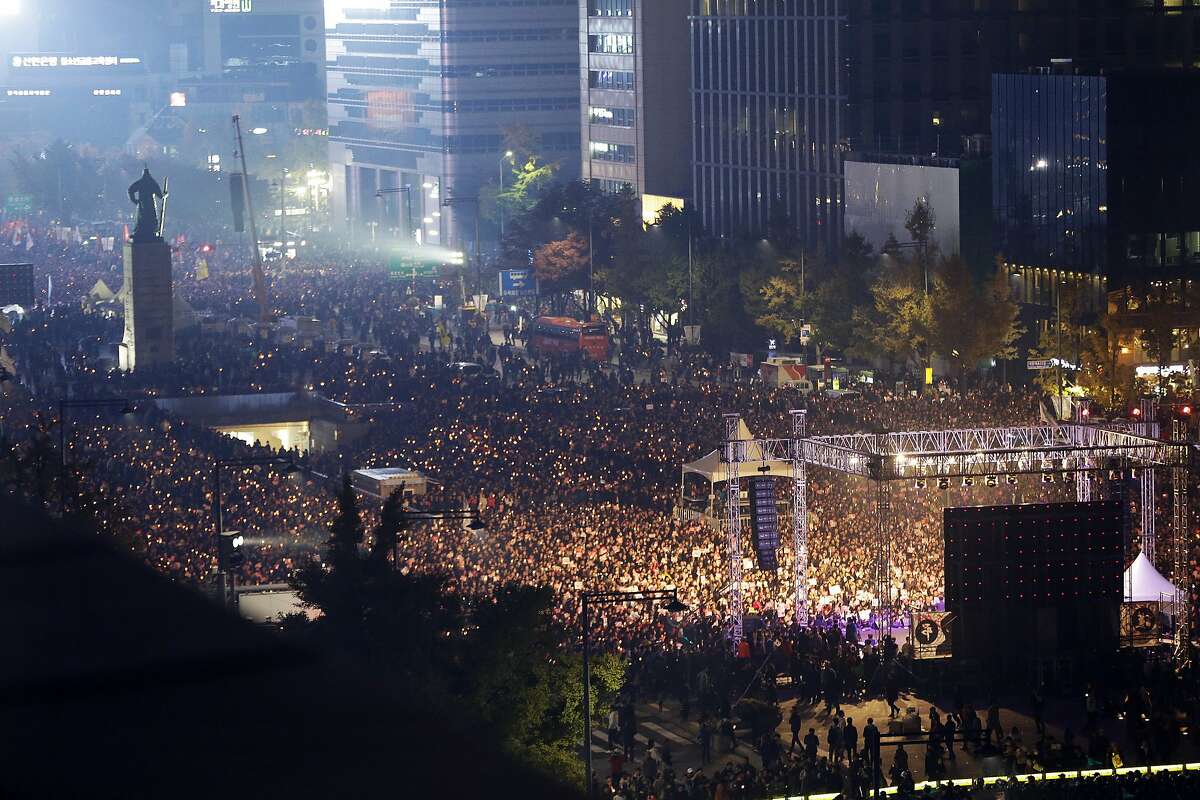 South Korean protesters stage a rally calling for South Korean President Park Geun-hye to step down in downtown Seoul, South Korea, Saturday, Nov. 5, 2016. Tens of thousands of South Koreans poured into the streets of downtown Seoul on Saturday, using words including "treason" and "criminal" to demand that Park step down amid an explosive political scandal. (AP Photo/Ahn Young-joon)
