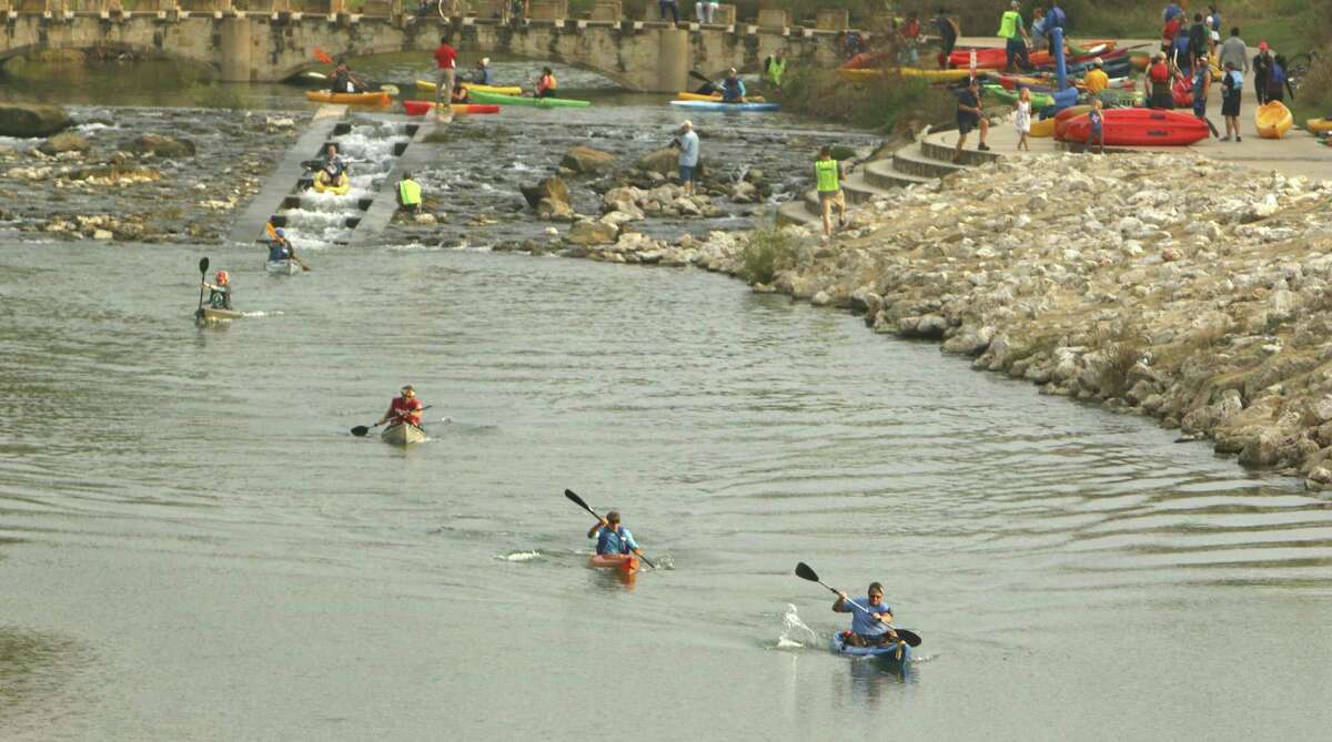 Kayakers near Concepción Park take part in the River Relay & Get Outdoors race and festival. The 4-kilometer race was accompanied by a 5-kilometer run.