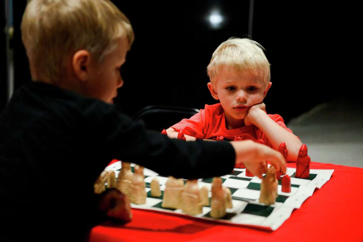 Baltazar and Hubert Kudlicki play chess together at the Houston Museum of Natural Science during the Ancient Games Festival on Saturday﻿. Irving Finkel, the British Museum's curator, said games reveal how societies develop.﻿