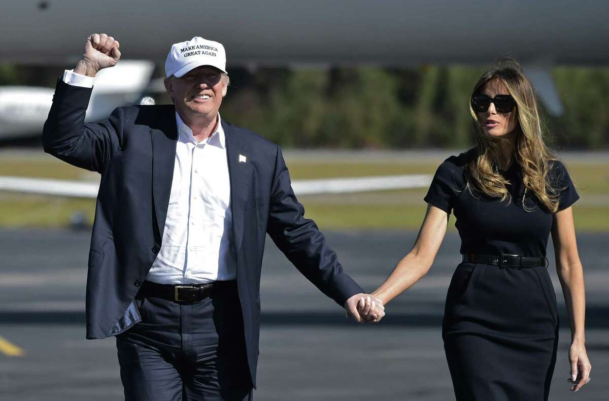 US Republican presidential nominee Donald Trump and his wife Melania make their way to a rally at Wilmington International Airport in Wilmington, North Carolina, days before the election.