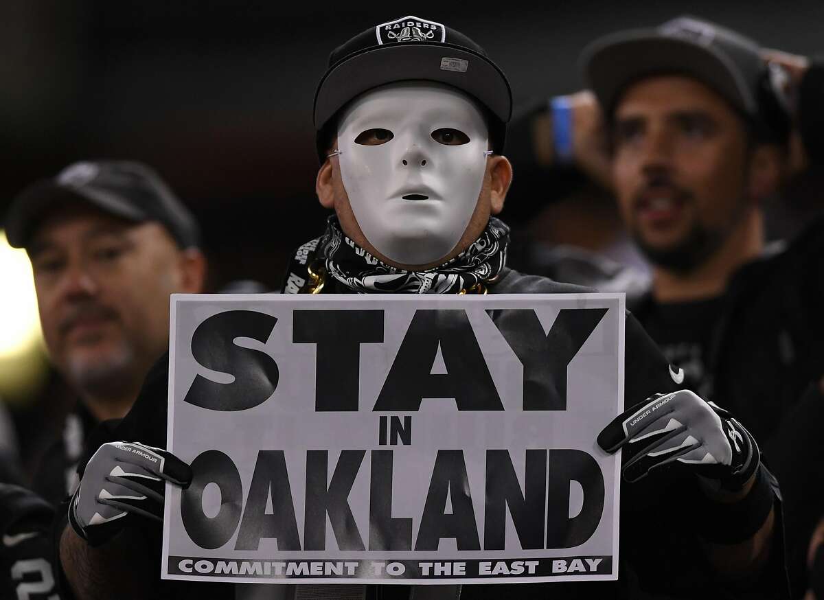 OAKLAND, CA - NOVEMBER 06: Oakland Raiders fans display signs in support of...