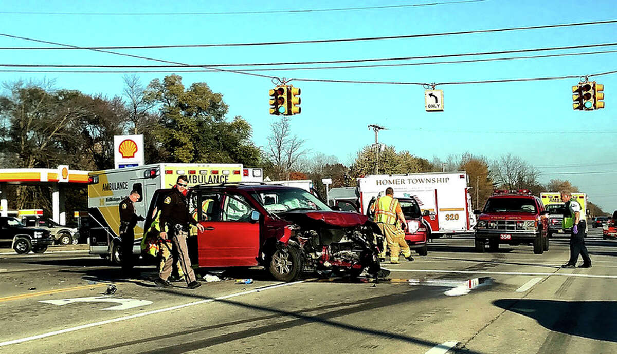 Sheriff's deputies and fire and rescue personnel work the scene of a three-vehicle accident at the intersection of M-20 and Meridian Road on Saturday.