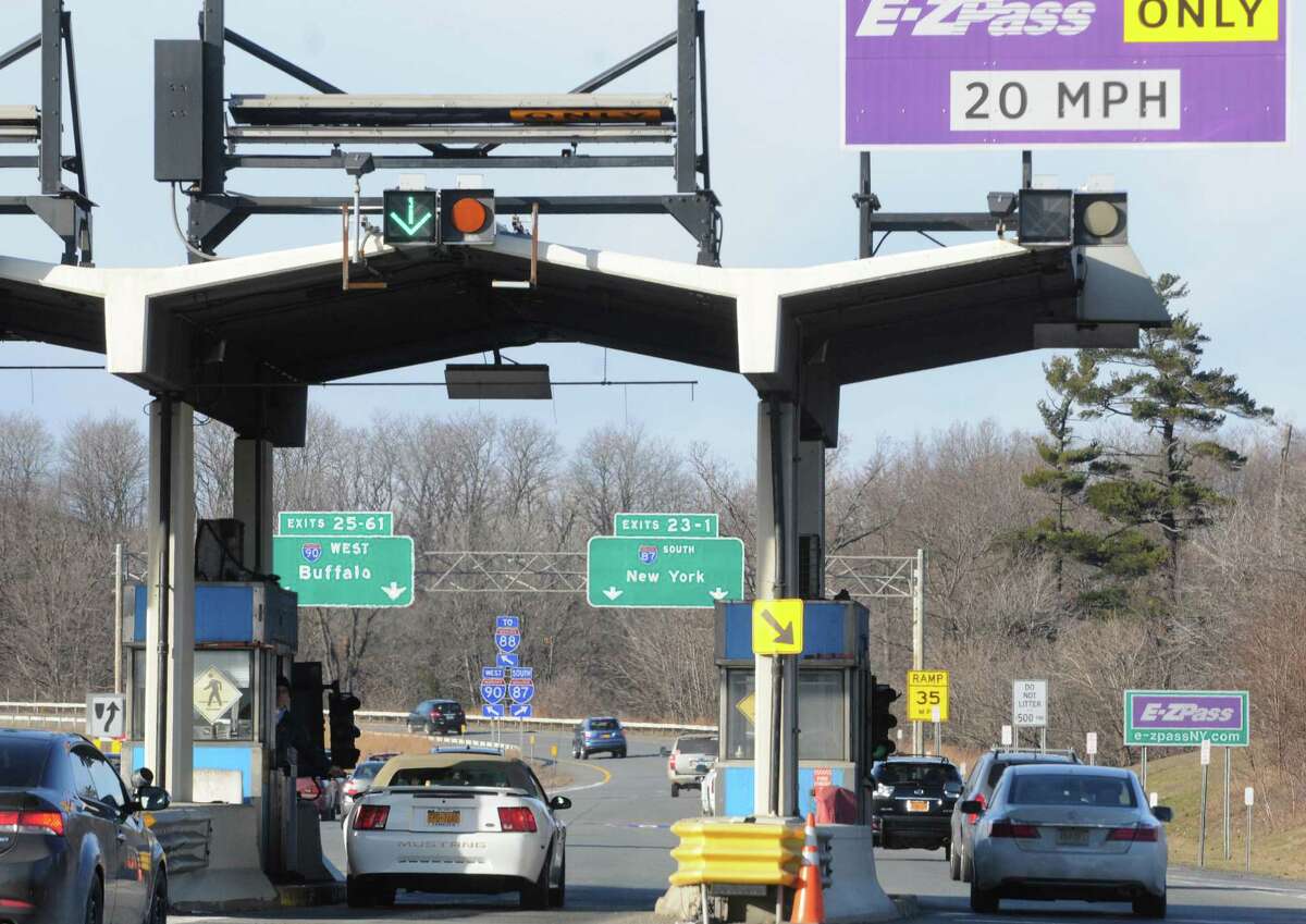 A New York State Thruway Authority toll collector works the booth next to an E-ZPass lane at Exit 24 on Wednesday Dec. 31, 2014, in Albany, N.Y. (Michael P. Farrell/Times Union)
