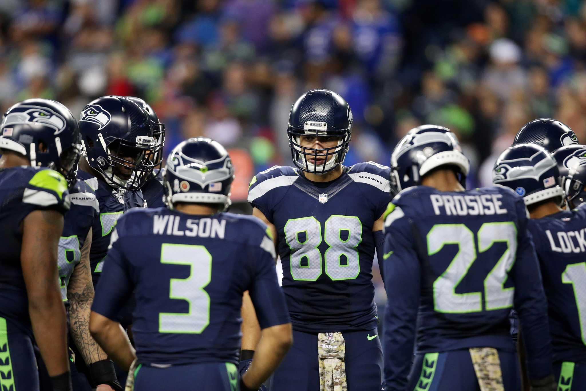 Seattle Seahawks strong safety Kam Chancellor (31)(R) celebrates his  interception with free safety Earl Thomas (29) with cornerback Richard  Sherman (25) and outside linebacker K.J. Wright (50) near by during the  first