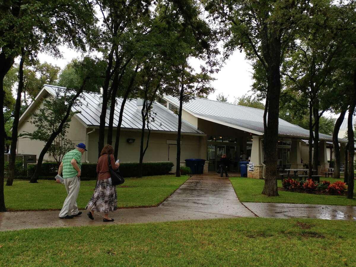 Voters head to a polling site at Woodlawn Baptist Church on a drizzly Election Day.