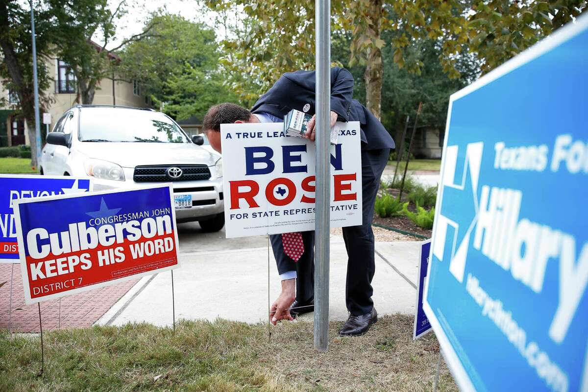 Democratic candidate for Texas House District 134 Ben Rose places a campaign sign outside of Horn Elementary School Tuesday, Nov. 8, 2016 in Houston.