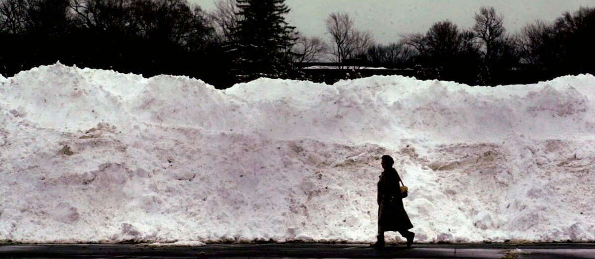 Feb. 6-7, 2003: A third major snowstorm of the winter dropped a foot of snow on the Albany area, helping push the snow total to the third snowiest winter on record.A woman passes a huge pile of collected snow that rests in the Colonis Center parking lot on Feb. 18, 2003.