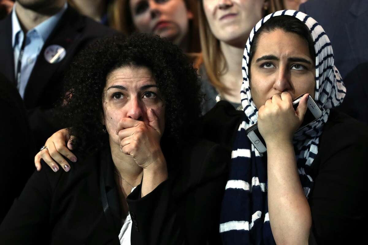 Two women hold their faces as they watch voting results at Democratic presidential nominee former Secretary of State Hillary Clinton's election night event at the Jacob K. Javits Convention Center November 8, 2016 in New York City. Clinton is running against Republican nominee, Donald J. Trump to be the 45th President of the United States. (Photo by Win McNamee/Getty Images)