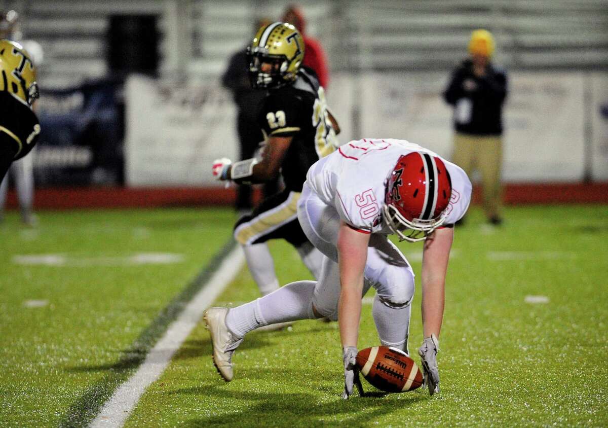 New Canaan's Seamus O'Hora recovers a fumble by Trumbull's Markeese Woods during high school football action in Trumbull, Conn. on Friday Nov. 4, 2016. O'Hora lost possesion but it was picked up by teammate Grant Morse and taken to the endzone to score.
