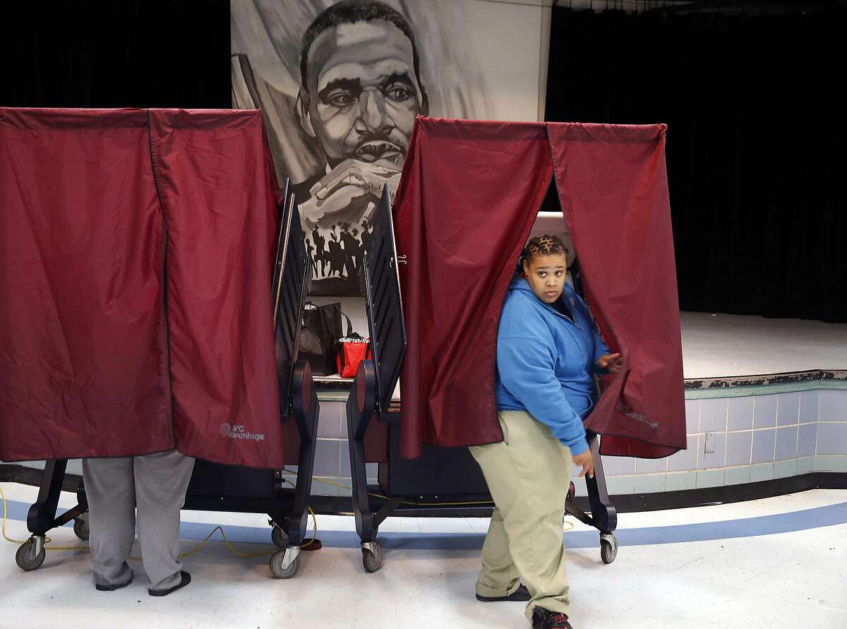 Ronique Slack exits a polling booth after casting her vote on Election Day at the Martin Luther King, Jr. Charter School in the Lower 9th Ward of New Orleans, Tuesday, Nov. 8, 2016. (AP Photo/Gerald Herbert)