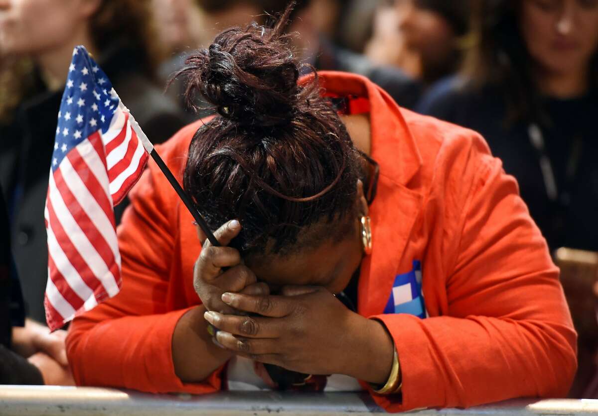 Marta Lunez, supporter of US Democratic presidential nominee Hillary Clinton, reacts to elections results during election night at the Jacob K. Javits Convention Center in New York on November 8, 2016.