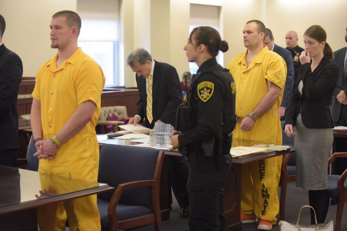 Michael Chmielewski, left in yellow, and Sean Moreland, right in yellow, in court for sentencing for their roles in the killing of Colonie barber Jacquelyn Porreca. (Paul Buckowski / Times Union)