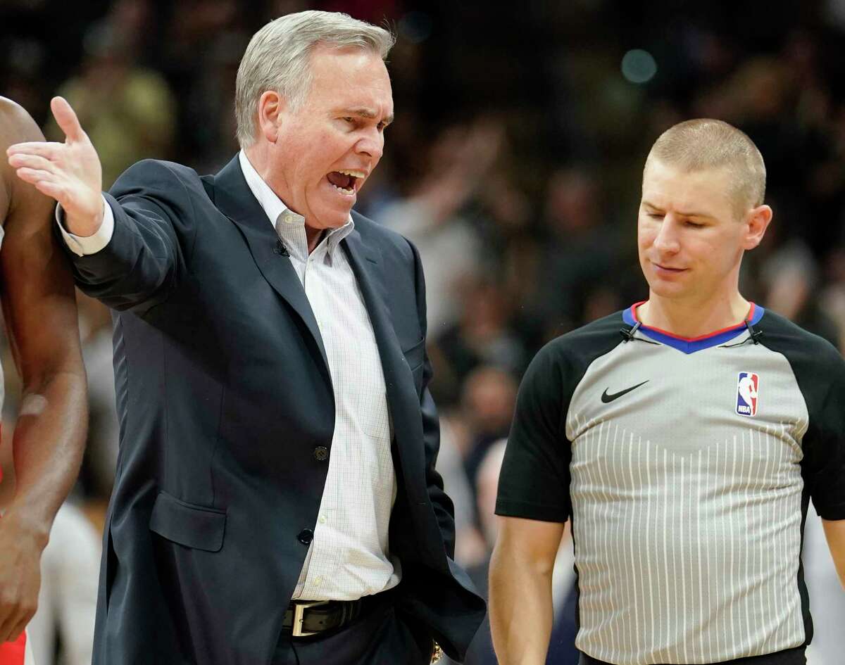 Houston Rockets head coach Mike D'Antoni, left, argues a call with referee Tyler Ford during the first half of an NBA basketball game against the San Antonio Spurs, Sunday, April 1, 2018, in San Antonio. (AP Photo/Darren Abate)