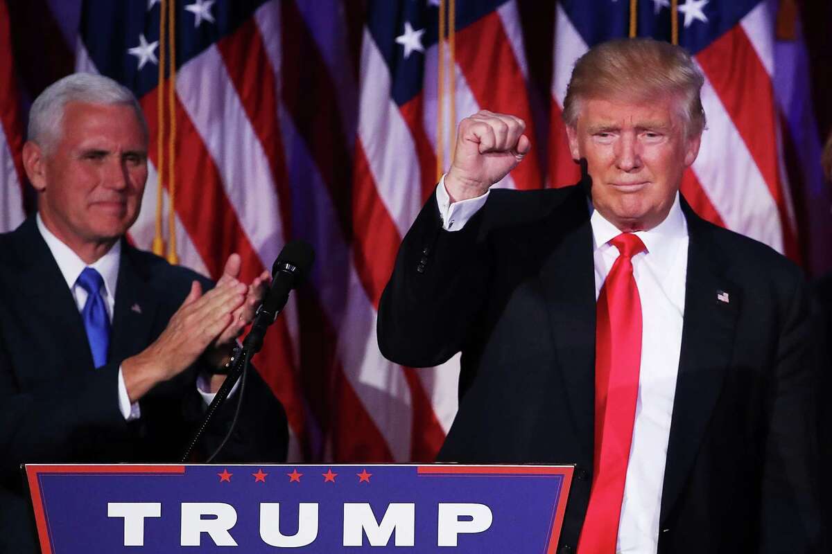 Republican president-elect Donald Trump acknowledges the crowd as Vice president-elect Mike Pence looks on during his election night event at the New York Hilton Midtown in the early morning hours of November 9, 2016 in New York City. Donald Trump defeated Democratic presidential nominee Hillary Clinton to become the 45th president of the United States.  