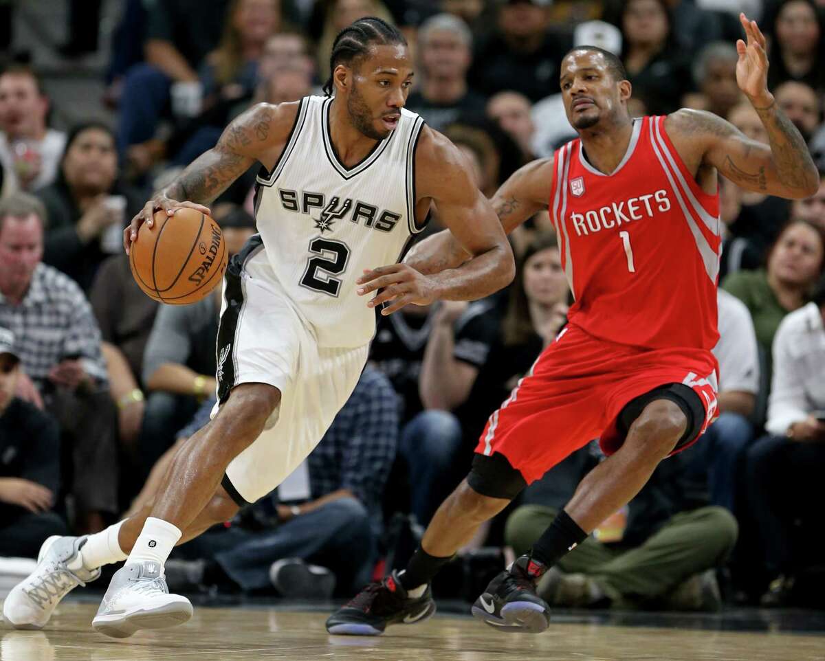 San Antonio Spurs' Kawhi Leonard looks for room around Houston Rockets?• Trevor Ariza during second half action Monday March 6, 2017 at the AT&T Center. The Spurs won 112-110.