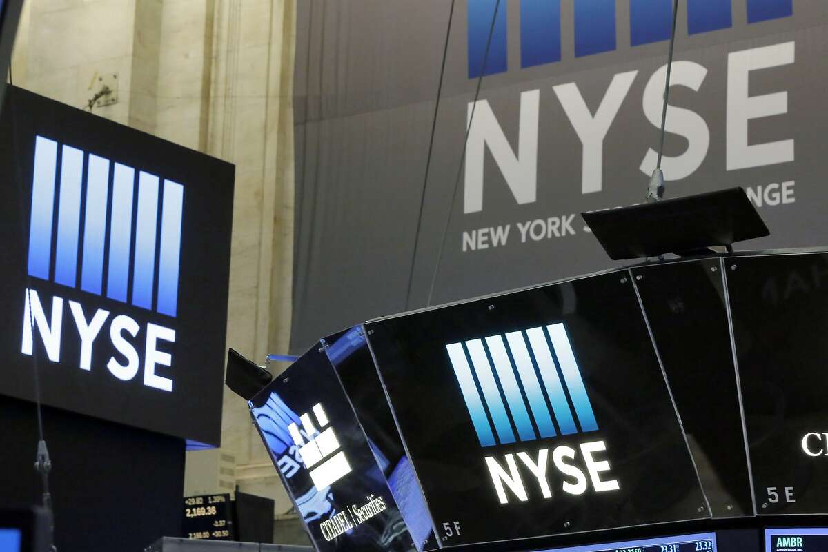 The top of a trading post and an NYSE banner above the trading floor of the New York Stock Exchange are seen Wednesday.