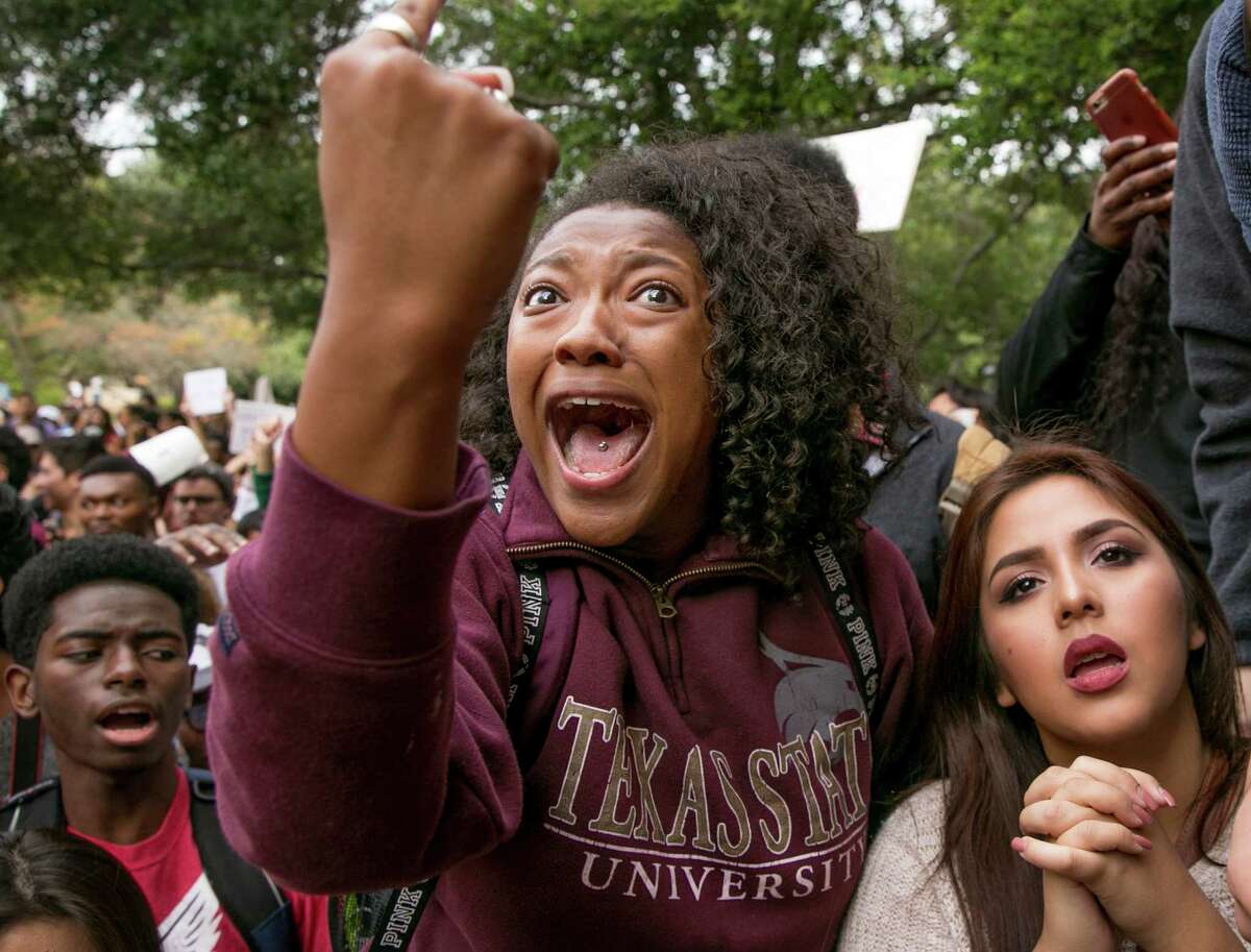 Arielle Moore, 19, argues with a Trump supporter during a protest at Texas State University in San Marcos, Texas, Thursday Nov. 10, 2016, opposition of Donald Trump's presidential election victory. (Jay Janner/Austin American-Statesman via AP)