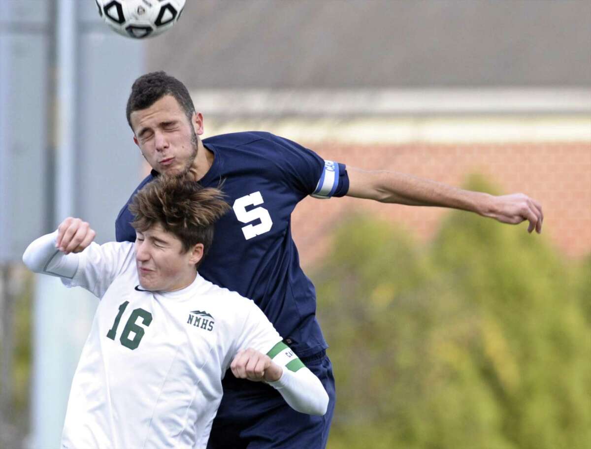 Staples Josh Berman (15) heads the ball over New Milford's Matthew Adamou (16) in the boys Class LL state soccer tournament game between Staples and New Milford high schools, on Thursday afternoon, November 10, 2016, at New Milford High School, in New Milford, Conn. Staples defeated New Milford 2-0 for the win.