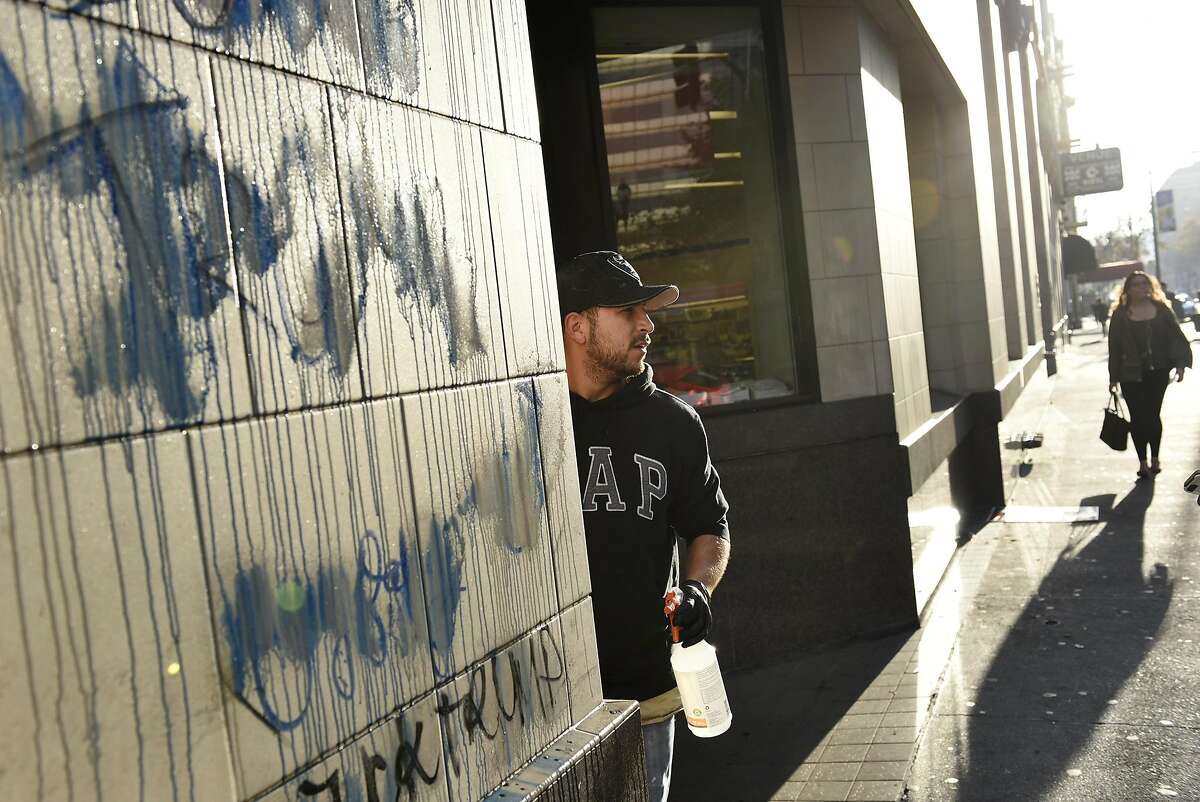 Gerardo Torres with RC Maintenance cleans graffiti off of Rite Aid on Broadway and 14th St. following overnight protests against the election of Donald Trump, in Oakland, CA, Thursday, November 10, 2016.