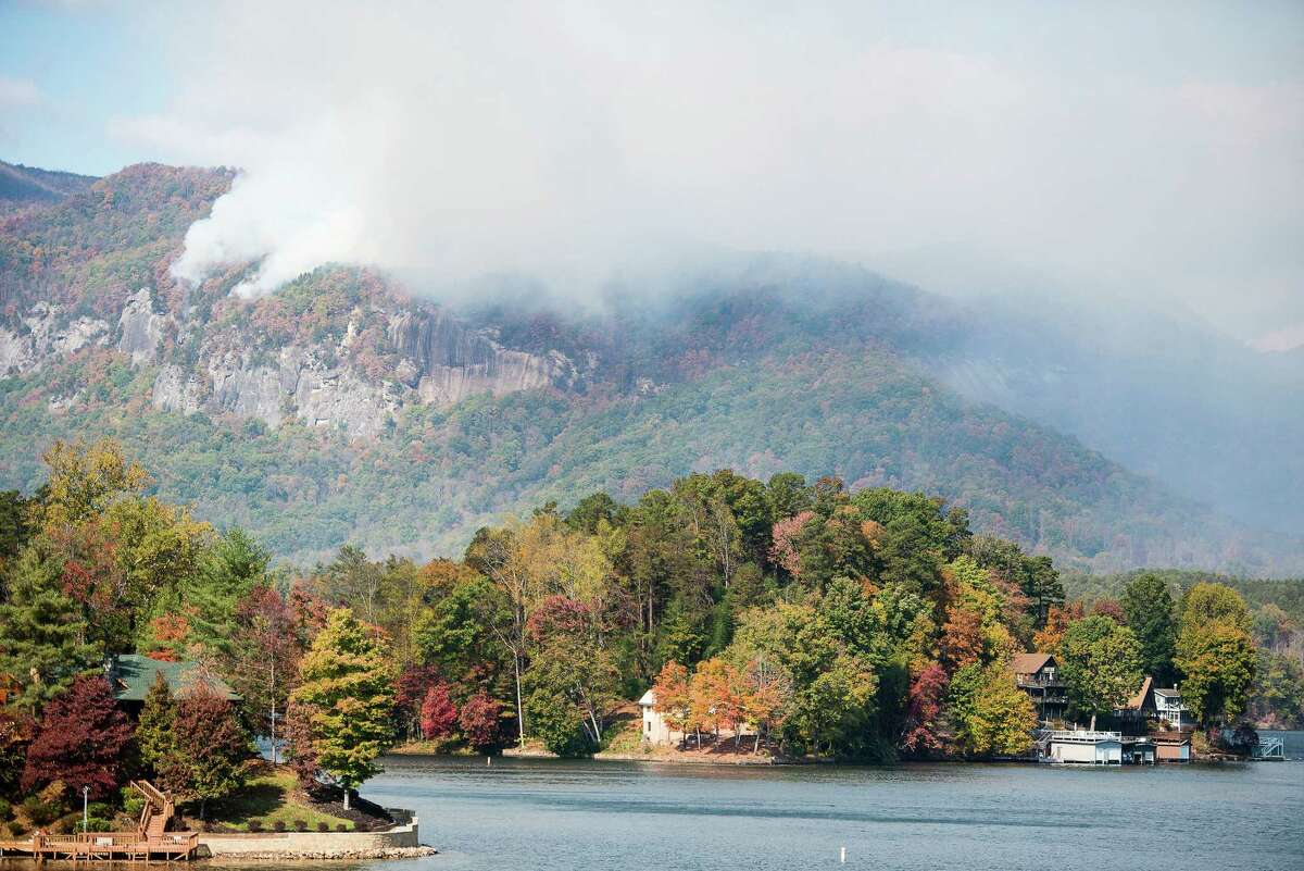 Smoke from the Party Rock fire near Lake Lure spreads as emergency services and the N.C. Forest Service work to contain the blaze Wednesday Nov. 9, 2016 at Lake Lure, N.C. Unseasonably warm dry weather has deepened a drought that's igniting forest fires across the southeastern U.S. (Abigail Margulis/The Asheville Citizen-Times via AP) ORG XMIT: NCASH103
