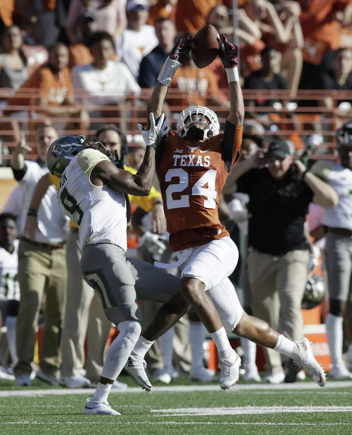 Texas cornerback John Bonney (24) breaks up a pass intended for Baylor wide receiver KD Cannon (9) during the first half on Oct. 29, 2016, in Austin.
