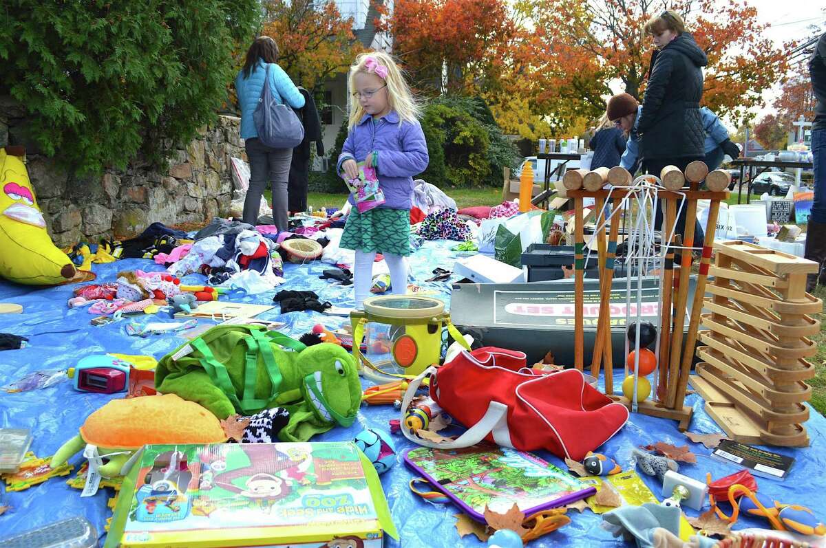 Alexandra Knowles, 4, of New Canaan, looks at some merchandise at the Junior League of Stamford-Norwalk’s fall tag sale, Sunday in Darien.