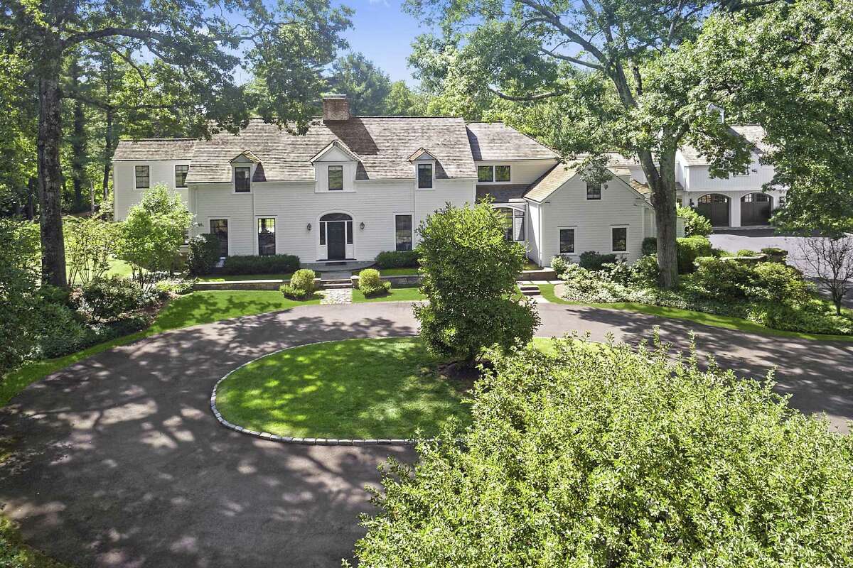 The front of this colonial house at 1018 Weed Street has a circular driveway that serves as the formal entrance while a large driveway and parking area by the two garages is the more casual family entrance.