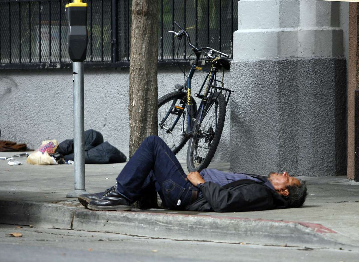 NEVIUS11_001_KK.JPG San Francisco's new "sit-lie" laws will make it easier for police to cite those sleeping, loitering and aggressively panhandling on city streets. This person was sleeping on Golden Gate and between Jones and Leavenworth at about 12:30 Wednesday. Photo by Kim Komenich/The Chronicle ** Ran on: 10-11-2007 This sleeping person at Larkin and McAllister streets in the early afternoon justifies the question citizens are debating, What do we do about this? Ran on: 10-11-2007 A person lying on the sidewalk is a common sight in San Francisco, as in this street scene Wednesday afternoon at Larkin and McAllister.--- Sent 06/06/12 14:56:20 as insight10_diaz_PH3 with caption: