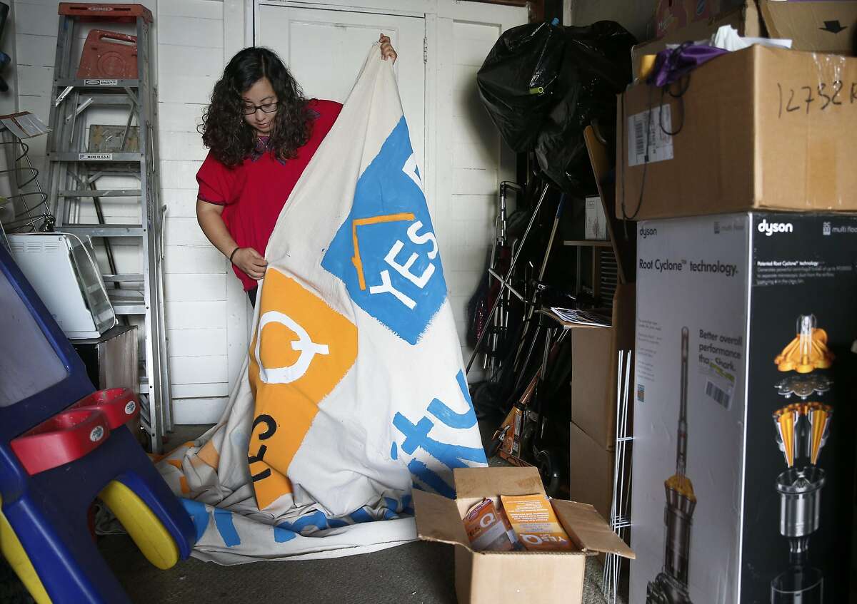 Noelia Corzo folds up a large Measure Q banner inside her garage in San Mateo, Calif. on Friday, Nov. 11, 2016. Corzo volunteered for the Yes on Measure Q campaign but the rent control initiative was rejected by San Mateo voters.