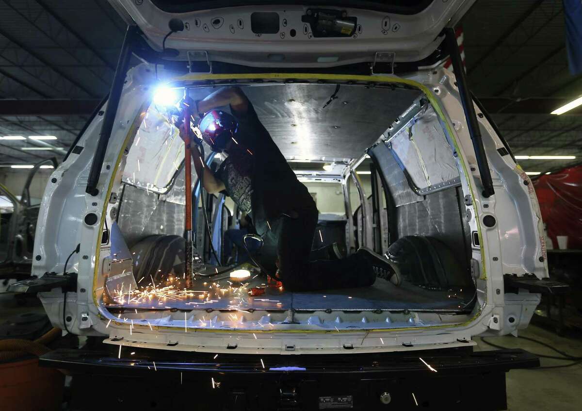 A Texas Armoring Corporation employee welds metal panels to armor an SUV at the company’s San Antonio facility.