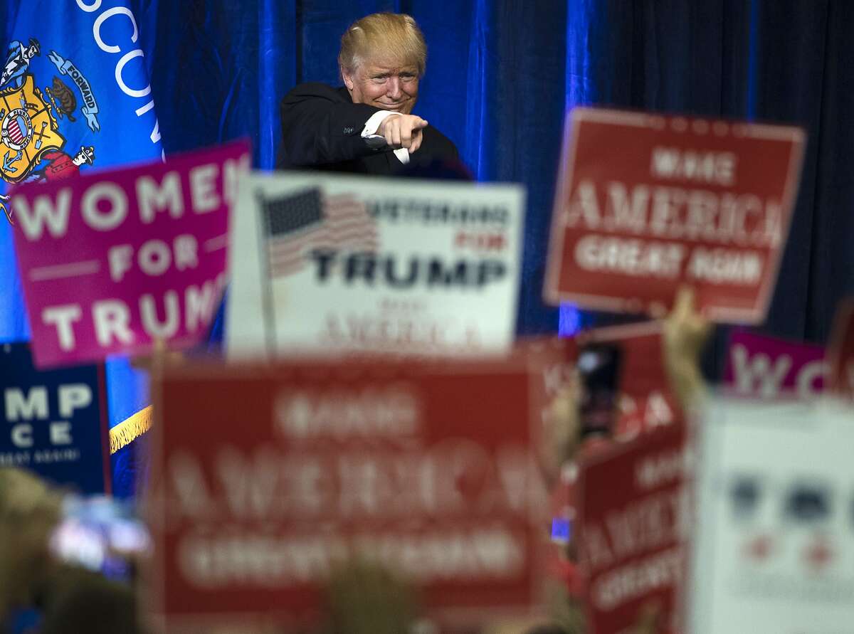 FILE - In this Tuesday, Nov. 1, 2016, Republican presidential candidate Donald Trump gestures during a campaign state at the University of Wisconsin-Eau Claire in Eau Claire, Wis. In his victory speech, Trump called them America�s �forgotten men and women�, the workers from the coalfields of Appalachia to the hallowing manufacturing towns of the Rust Belt who propelled him to an improbable victory. They felt left behind by progress, laughed at by the elite, and so put their faith in the billionaire businessman with a sharp tongue and short temper. (AP Photo/Matt Rourke, File)