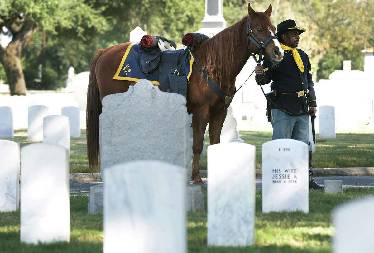 Bobby Ray Carter, a member of the Bexar County Buffalo Soldiers, stands with his horse during a Veterans Day Commemorative Ceremony presented by the Bexar County Buffalo Soldiers at San Antonio National Cemetery on Friday, Nov. 11, 2016.