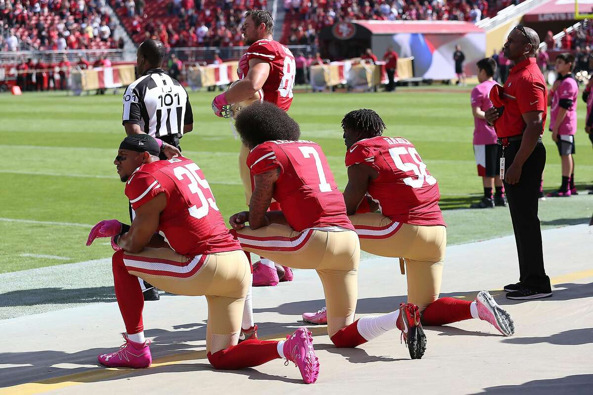 Colin Kaepernick of San Francisco 49ers sits during national