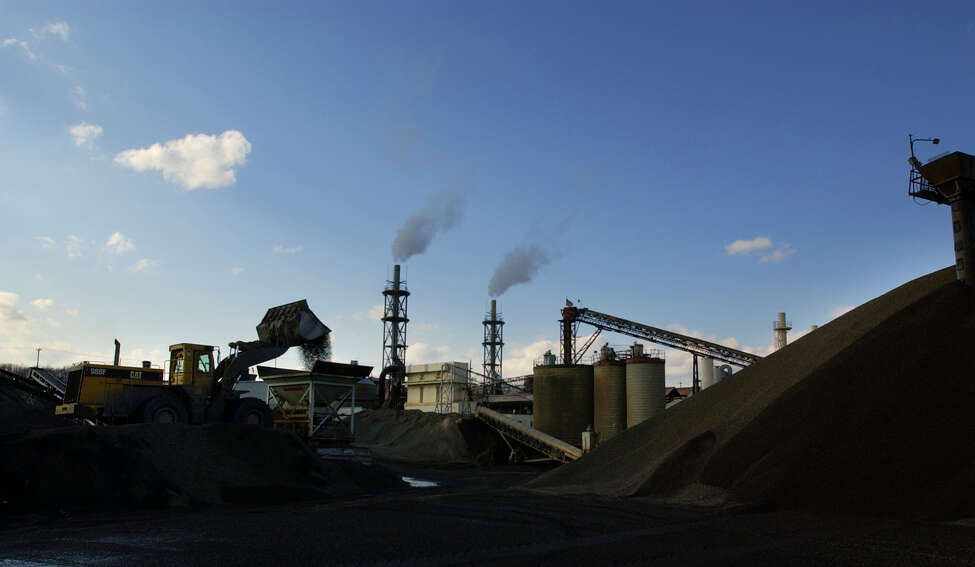 Mike Connell, loader operator at Norlite Corp., dumps a load of 3/4 inch aggregate into a crusher which will produce smaller aggregate at Norlite on Monday, March 15, 2004, in Cohoes, N.Y. (Paul Buckowski / Times Union archive)