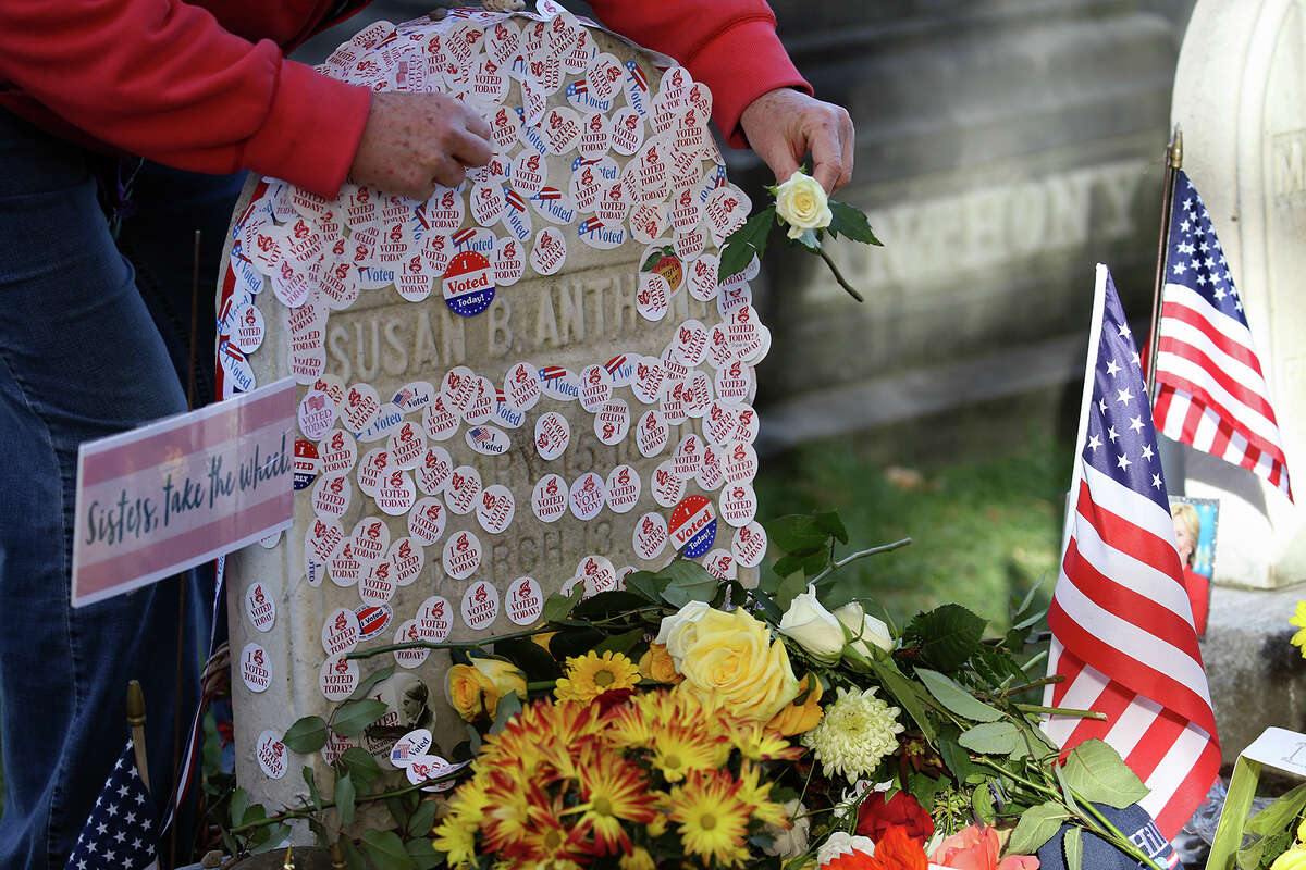 Voters lined up on Election Day to place "I voted" stickers on the grave of Susan B. Anthony at Mt. Hope Cemetery in Rochester, NY., Tuesday, Nov. 8, 2016. (Max Schulte /Democrat & Chronicle via AP)
