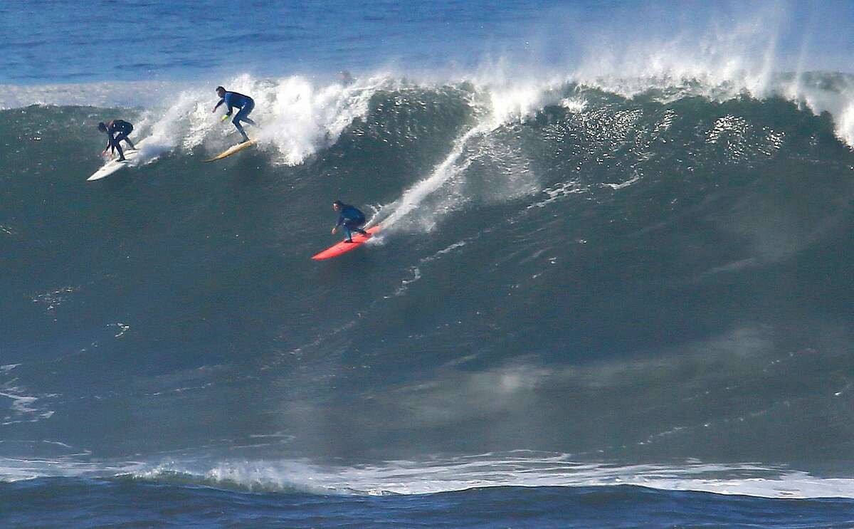 A group of surfers including Bianca Valenti, (right)take off on a wave at the Mavericks break in Half Moon Bay, California, on Friday November 4, 2016