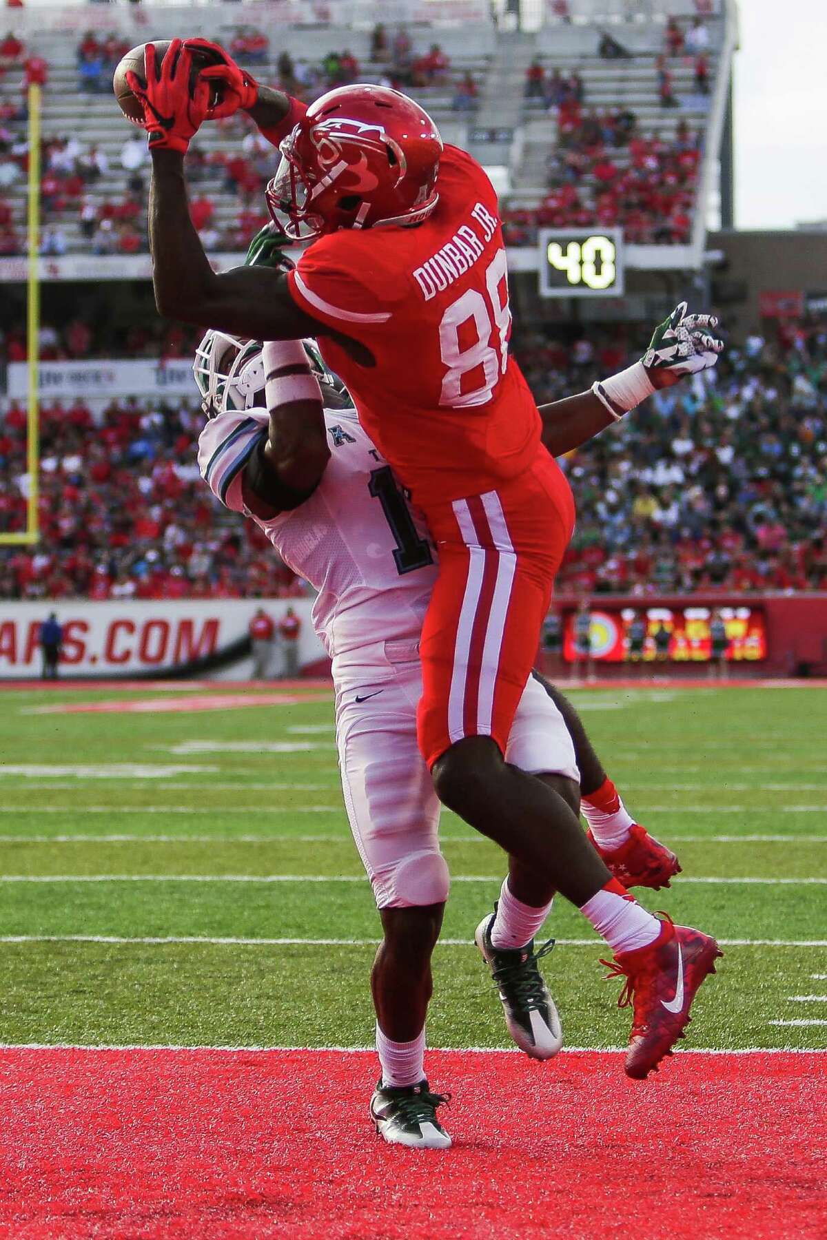 Houston Cougars wide receiver Steven Dunbar (88) catches a touchdown pass over Tulane Green Wave defensive back P.J. Hall (16) as the Houston Cougars take on the Tulane Green Wave at TDECU Stadium Saturday, Nov. 12, 2016 in Houston.