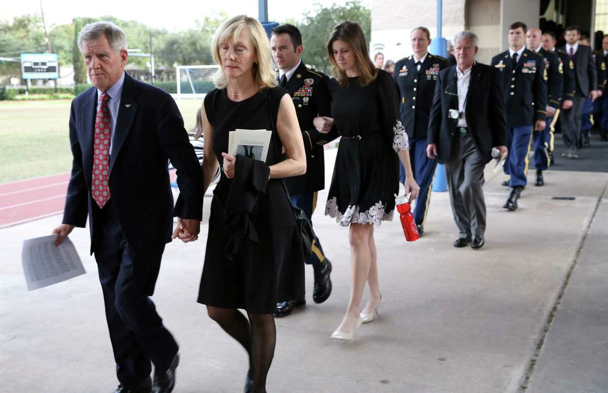 Family members of Jimmy Moriarty, U.S. Army Special Forces soldier who was killed in Jordan last week, followed by army members leaving the Annunciation Orthodox School gym after the memorial service Saturday, Nov. 12, 2016, in Houston. Among them are Moriarty's father, James Moriarty, left, and older sister, Rebecca Moriarty, fourth from left.