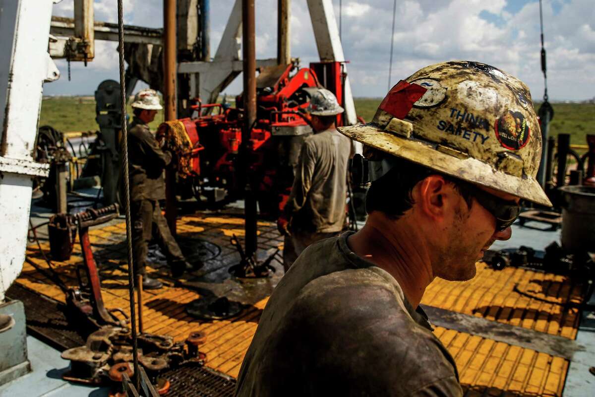 Helmerich & Payne floor hand Jeremy Lewellyan, right, operates controls to add a section of pipe as they drill for oil and gas on a Diamondback Energy lease Wednesday, Sept. 14, 2016 outside of Midland. ( Michael Ciaglo / Houston Chronicle )