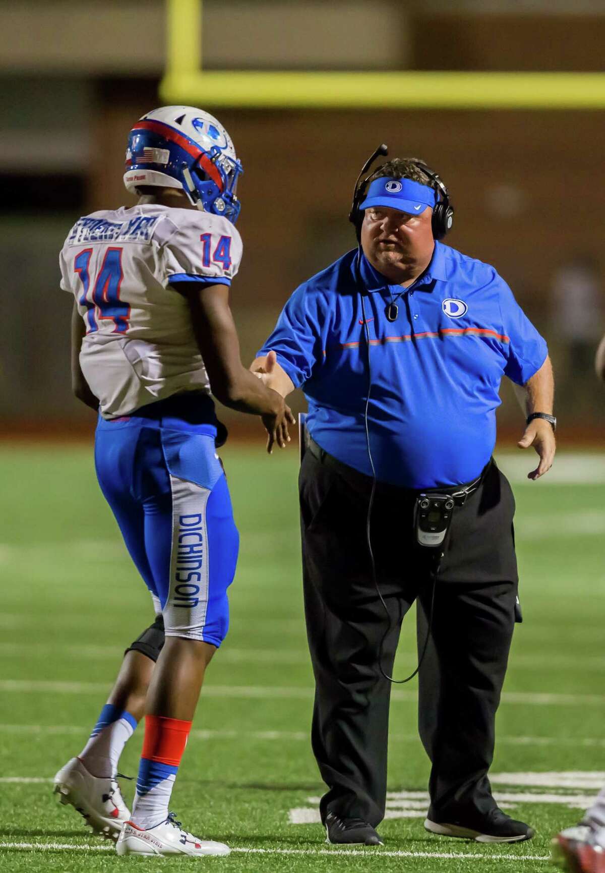 Nov. 12: Dickinson 35, Alief Taylor 21 Dickinson Gators head coach John Snelson congratulates Dickinson Gators Tyrese Wydermyer (14) for making a tackle during the 6A Division 1 playoff game between Alief Taylor and Dickinson at LeRoy Crump Stadium on November 12, 2016 in Houston, Texas. (Leslie Plaza Johnson/Freelance)