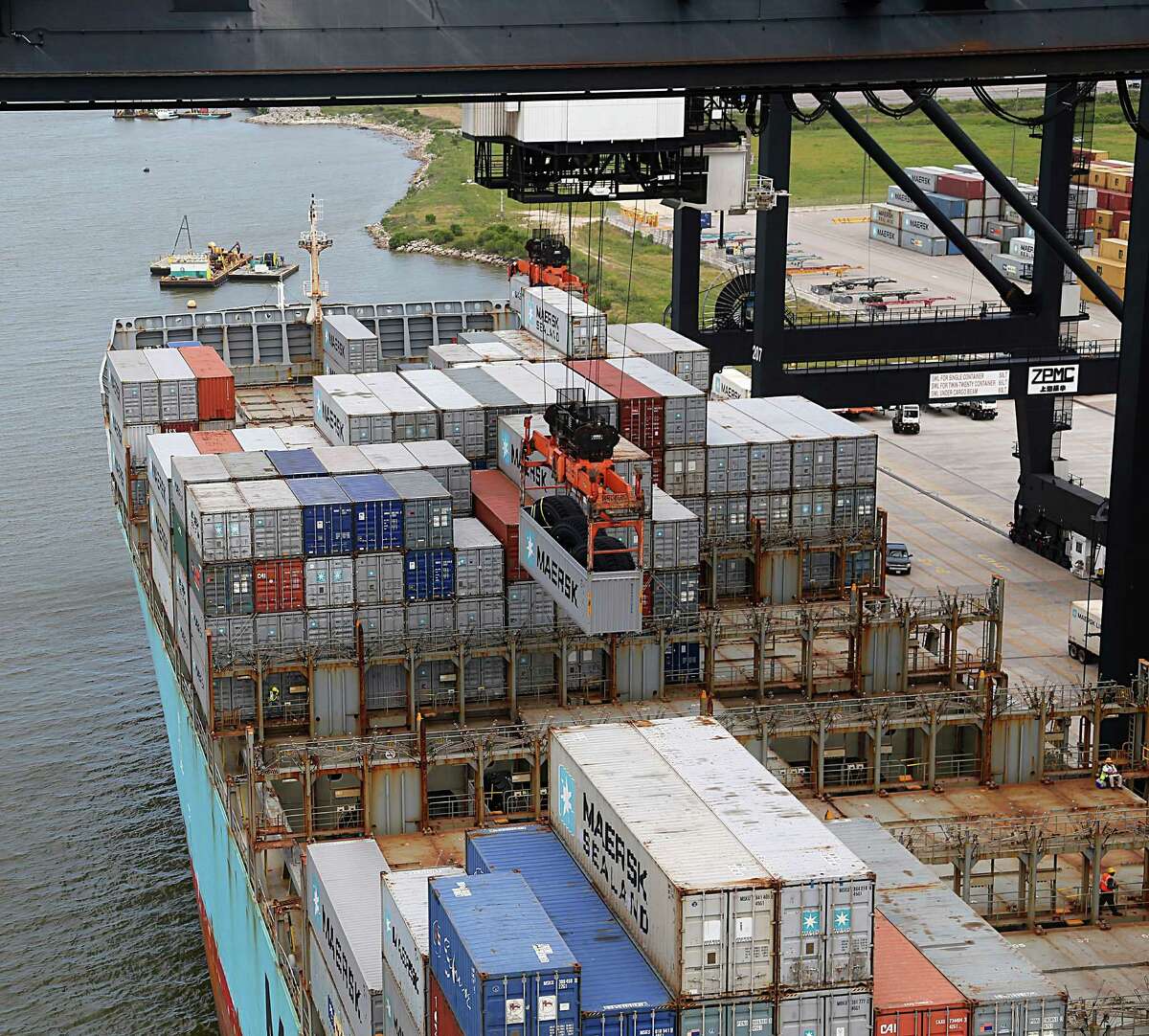 A crane unloads a container from a ship at the Port of Houston Authority, Bayport Container Terminal on June 22, 2016, in Seabrook. (James Nielsen / Houston Chronicle)
