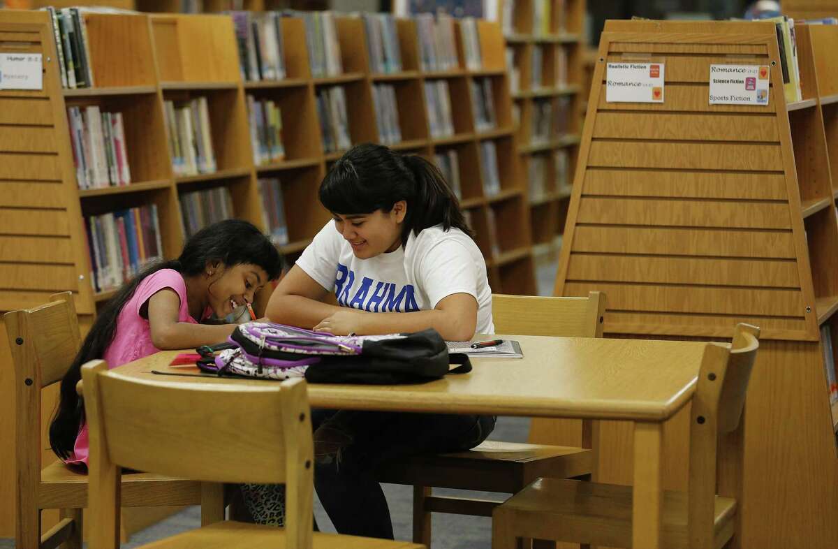 MacArthur High School senior Vanessa Piñeda (right) works on reading and grammar with Anisha Howlander during MacTeach. This is where students help tutor students from area elementary schools — including some international refugees and their families. A reader says proper grammar usage should be a higher priority in San Antonio.