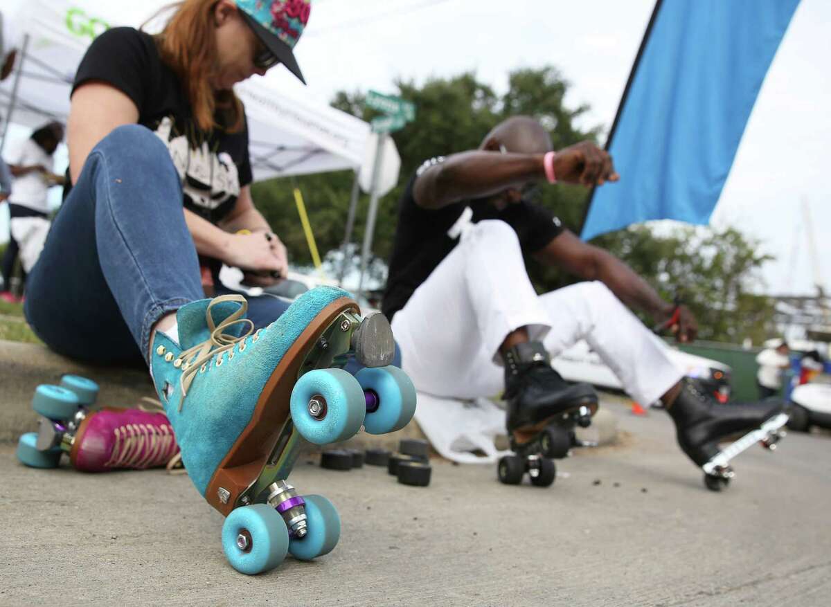 In this photo: Tawnya "T" King, left, and Leo "Skate King" Butler change skates at the Sunday Streets in Fifth Ward in 2016.